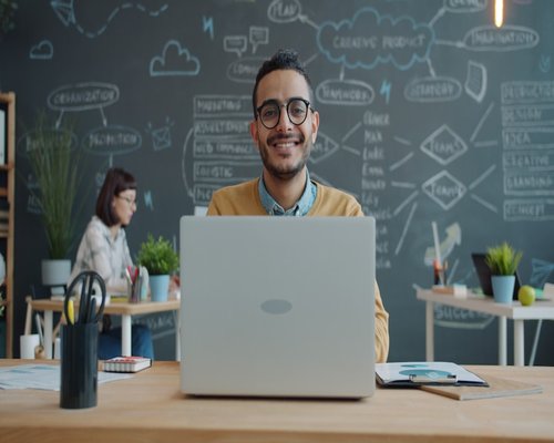 man wearing glasses at desk